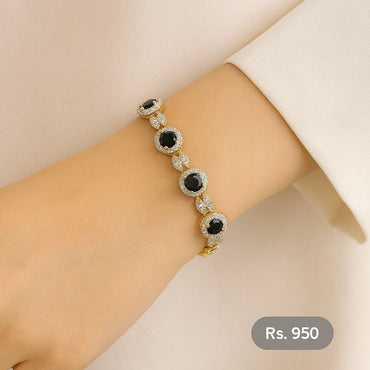 Gold-tone bracelet with black stones and CZ detailing on wrist – Destiny.pk