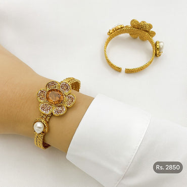 Gold-tone floral bracelet with orange crystal, pink pavé petals & pearl accents – Destiny.pk