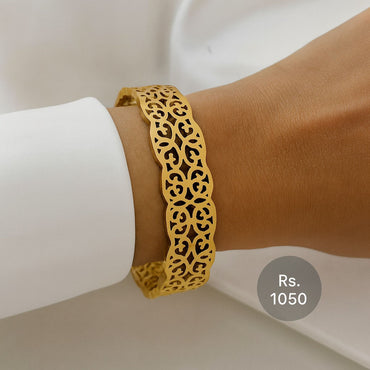 Gold-tone cutwork design bracelet on model wrist – Destiny.pk