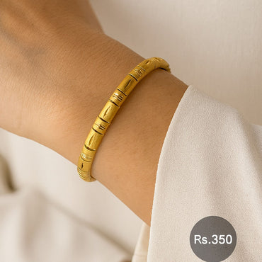 Minimalist gold-tone bracelet with engraved design on wrist – Destiny.pk
