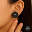 Black floral stud earrings with sparkle stone center – Destiny.pk