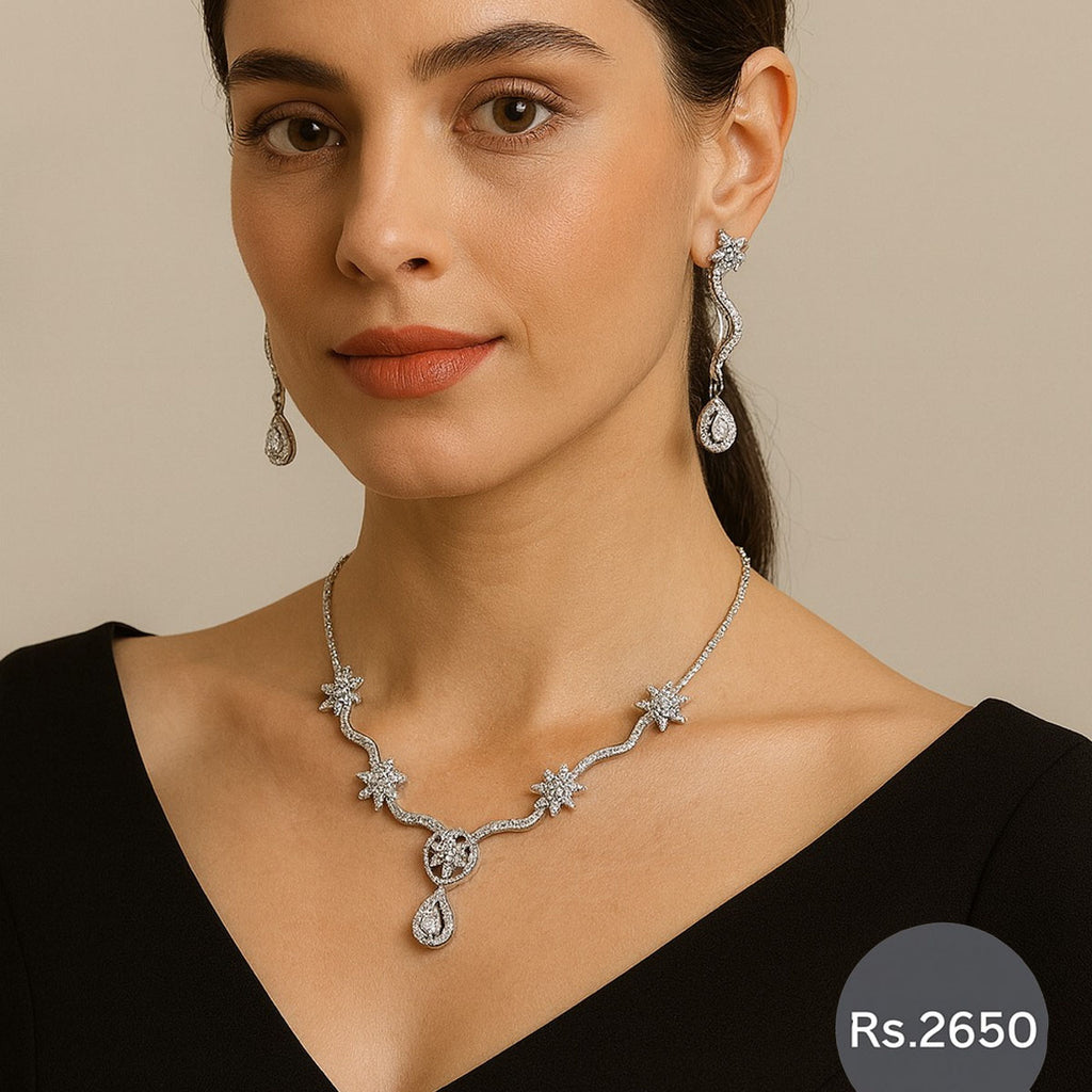 Silver crystal star necklace set with matching earrings.