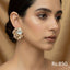 Gold-plated stud earrings with ruby, emerald, and sapphire-toned Kundan stones, priced at Rs. 850