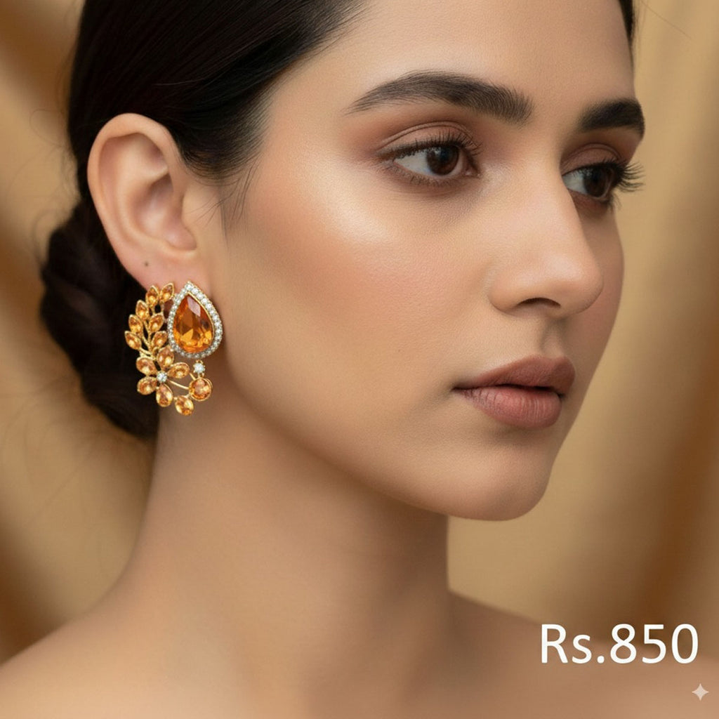 Gold-plated stud earrings with ruby, emerald, and sapphire-toned Kundan stones, priced at Rs. 850