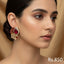 Gold-plated stud earrings with ruby, emerald, and sapphire-toned Kundan stones, priced at Rs. 850