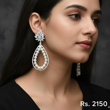 Silver-plated drop earrings with a diamante stud top and a large pear-shaped pearl dangle, priced at Rs. 2150 