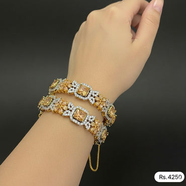 Gold-plated stone-studded bracelet pair with square-cut centerpiece stones, priced Rs. 4250