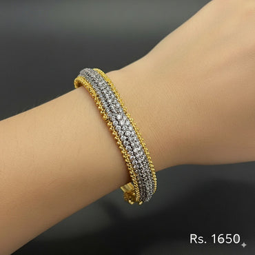 Dual-tone gold and silver stone bracelet on hand, priced Rs. 1650