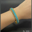 Dual-tone gold and silver stone bracelet on hand, priced Rs. 1650