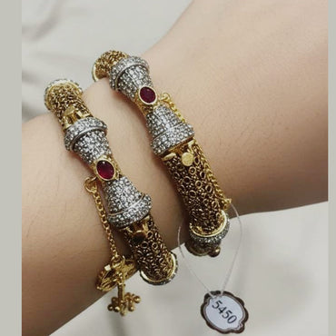 Gold plated bridal bangle set embellished with gemstones, priced Rs. 5450