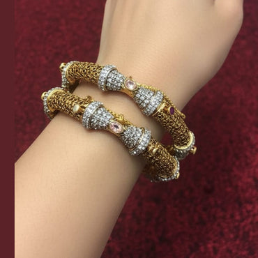 Gold plated bridal bangle set embellished with gemstones, priced Rs. 5450