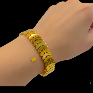 Chunky gold link bracelet with leaf motifs for women, priced Rs. 650