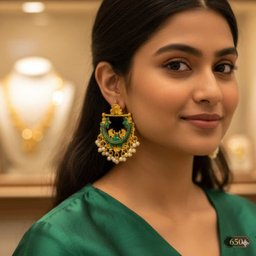 Green and gold peacock-inspired earrings with enamel design, priced Rs. 650