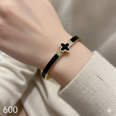 Dainty black enamel cuff bracelet with gold finish, priced Rs. 600