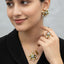 Designer gold-tone pearl and gemstone starburst cluster necklace set with matching earrings, priced Rs. 1850