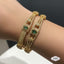 Statement Wide Gold Bangle with Emerald-Look Stone – Rs. 3,450