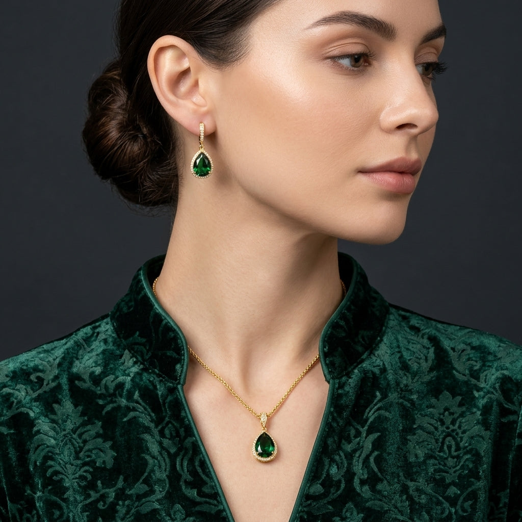 22K Gold-Tone Pear Emerald CZ Halo Pendant Necklace & Huggie Drop Earrings Jewelry Set worn on South Asian female model in emerald green velvet brocade dress with dark grey studio backdrop