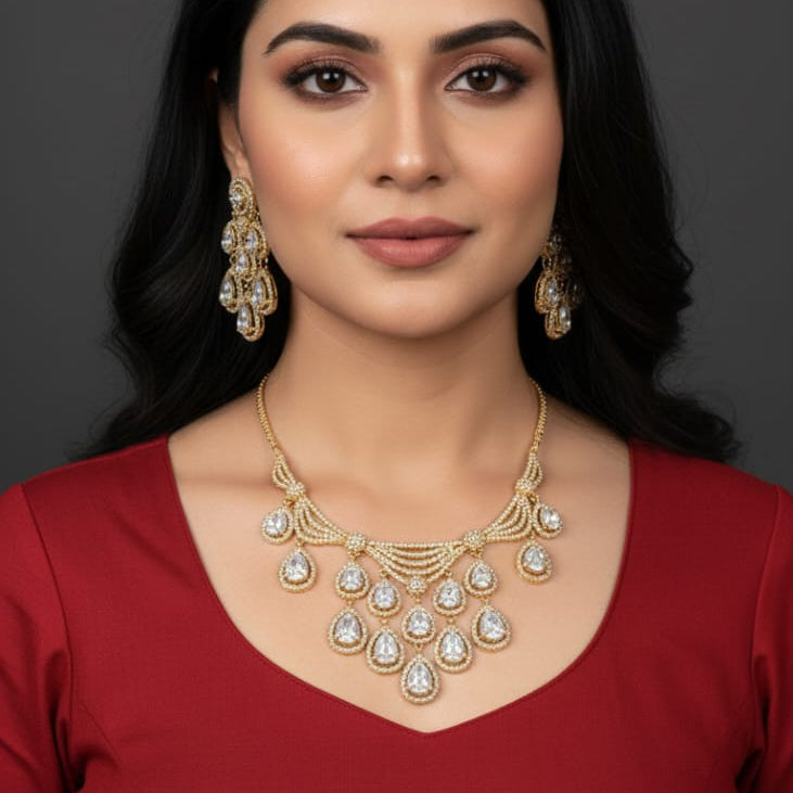 Woman wearing a gold necklace and earrings on a dark background
