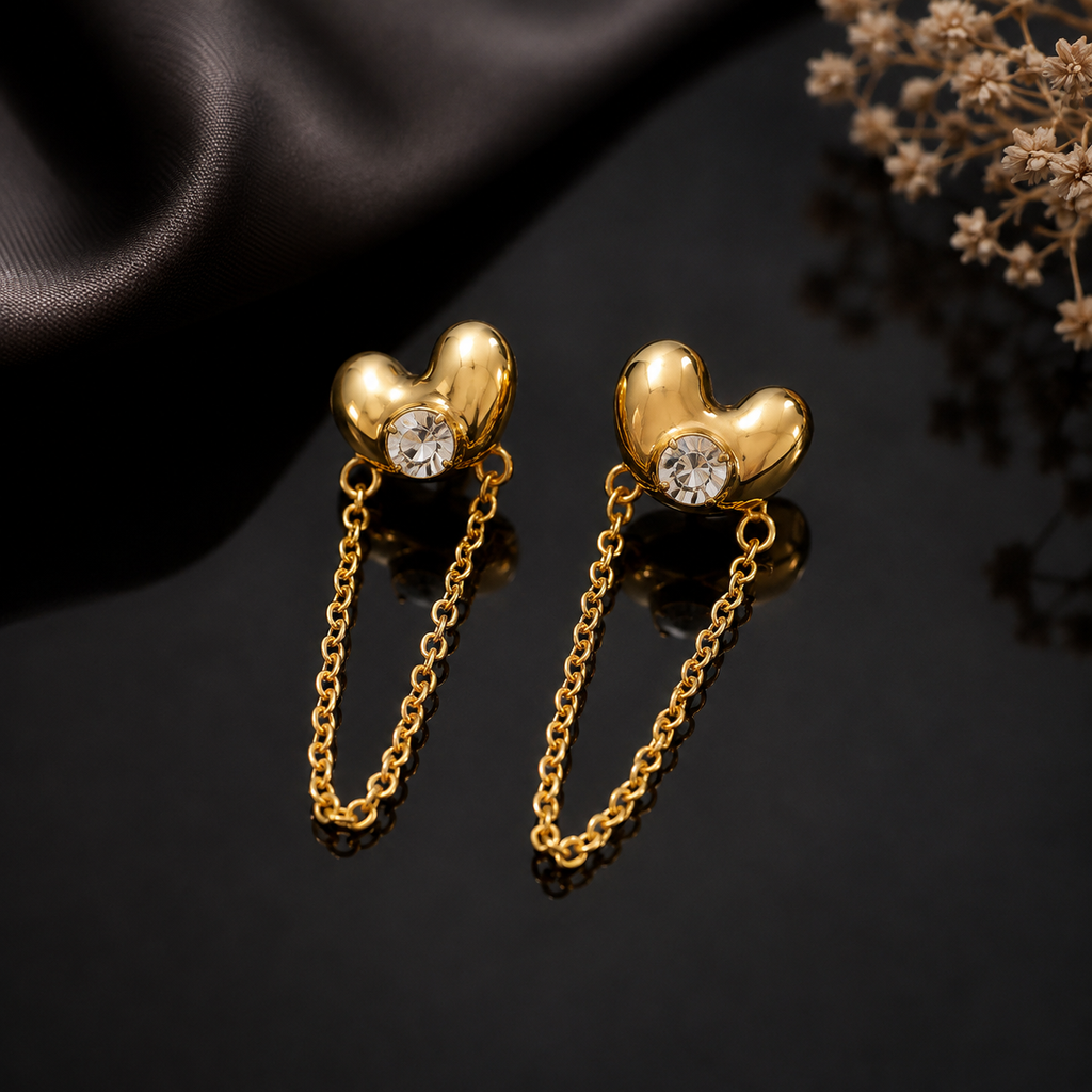 Golden heart-shaped chain drop earrings with sparkling center stones