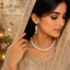 Elegant white pearl-style beaded necklace with matching drop earrings