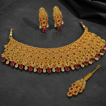 Ruby red American Diamond bridal choker set with matching earrings and maang tikka in golden finish