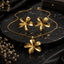 Golden five-petal floral necklace with matching earrings set