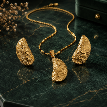 Golden textured leaf necklace with matching leaf-shaped earrings
