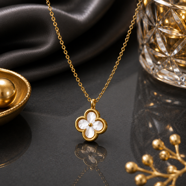 Elegant gold clover pendant necklace with white floral detailing