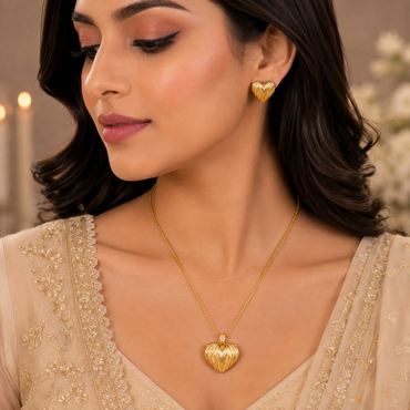 Golden heart pendant necklace with matching textured heart earrings