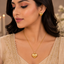 Golden heart pendant necklace with matching textured heart earrings