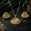 Golden shell-inspired fan pendant necklace with matching textured earrings
