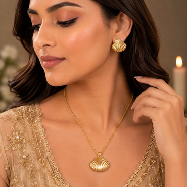 Golden shell-inspired fan pendant necklace with matching textured earrings