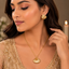 Golden shell-inspired fan pendant necklace with matching textured earrings