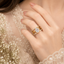 Golden triplet American diamond ring with large oval-cut center stone and sparkling triple bands