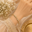 Elegant gold beaded bracelet with sparkling crystal centerpiece