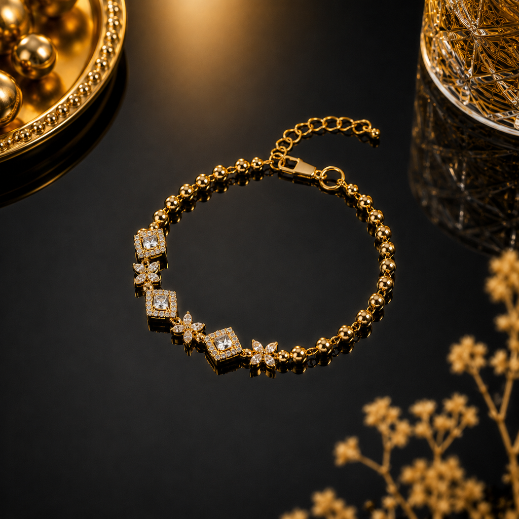 Gold beaded bracelet with sparkling crystal squares and butterfly accents