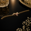 Gold butterfly bracelet with sparkling crystals and pink and red heart-shaped stones