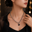 Black beaded necklace with elegant swan-shaped pendant