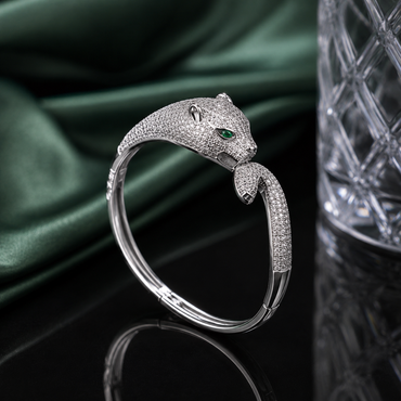 Luxury leopard head CZ cuff bracelet with sparkling stones and green eye accents in gold and silver-tone finishes
