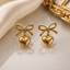 Elegant gold bow and heart drop earrings with polished gold-tone finish for women