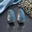 Elegant silver CZ hoop statement earrings with sparkling clear stones and polished silver-tone finish