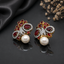 Elegant gold-tone crystal pearl statement earrings with intricate floral detailing and pearl drops