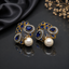 Elegant gold-tone crystal pearl statement earrings with intricate floral detailing and pearl drops