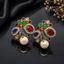 Elegant gold-tone crystal pearl statement earrings with intricate floral detailing and pearl drops