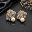 Elegant gold-tone crystal pearl statement earrings with intricate floral detailing and pearl drops