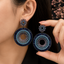 Luxury blue and purple crystal statement earrings with intricate circular detailing