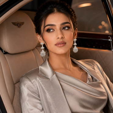 Elegant silver-tone crystal drop earrings with intricate sparkling stone detailing