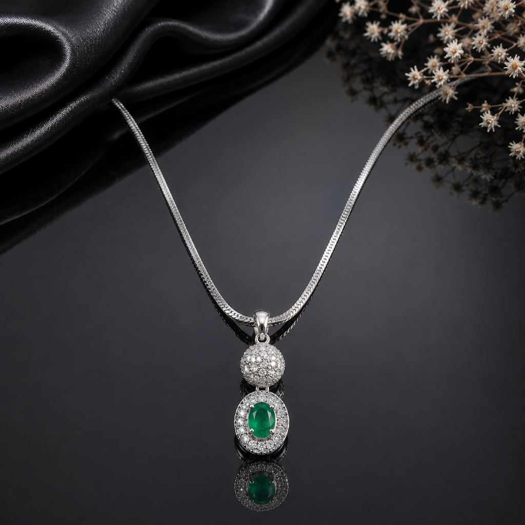 Elegant silver-tone pendant necklace with emerald green crystal and sparkling stones