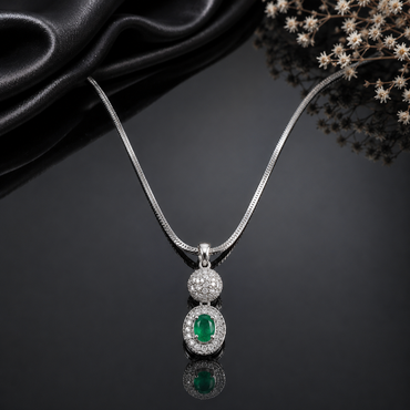 Elegant silver-tone pendant necklace with emerald green crystal and sparkling stones