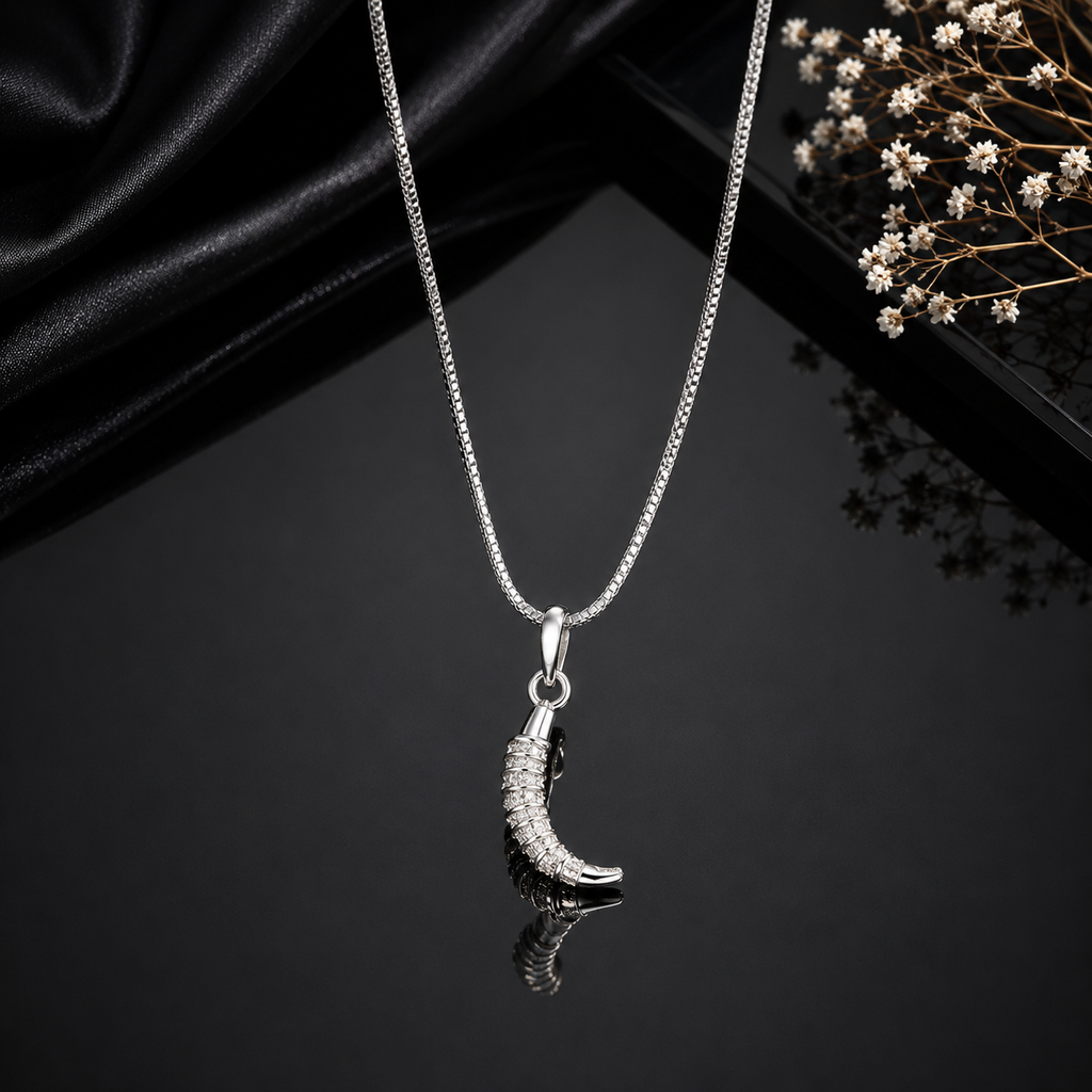 Elegant silver-tone crescent moon pendant necklace with sparkling stone detailing and sleek chain
